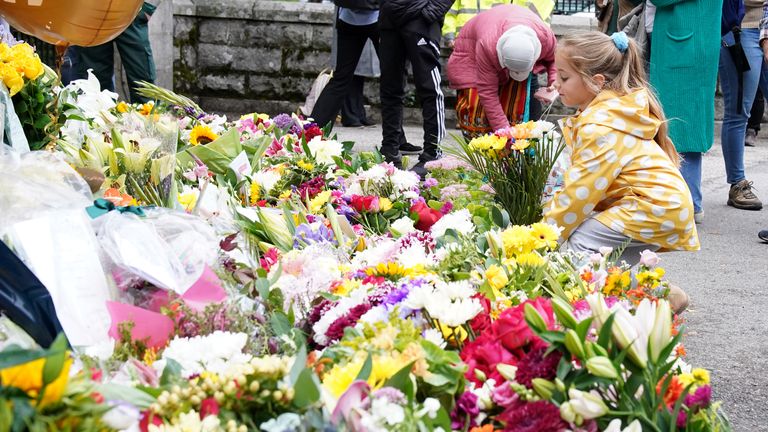 Six-year-old Terezka Cernianska lays flowers at the gates of Balmoral 