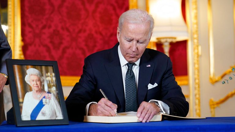 Joe Biden signs a book of condolence for the Queen at Lancaster House. Pic: AP