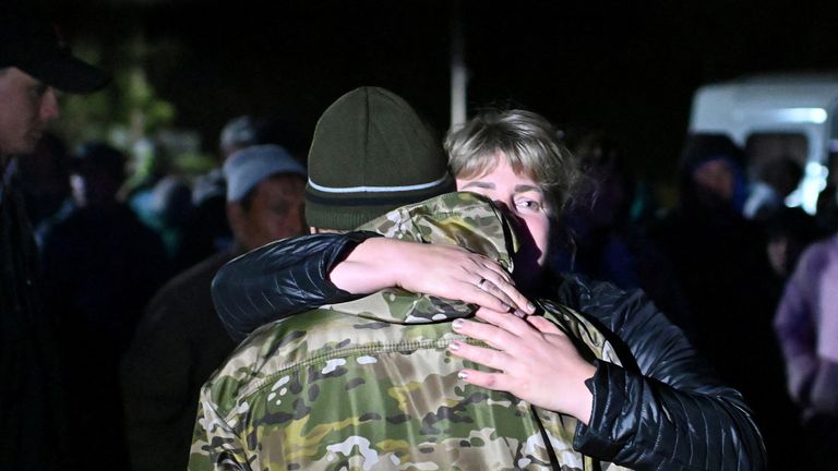 A woman bids farewell to a reservist drafted during the partial mobilisation in the Siberian settlement of Bolsherechye in the Omsk region, Russia September 25, 2022. REUTERS/Alexey Malgavko
