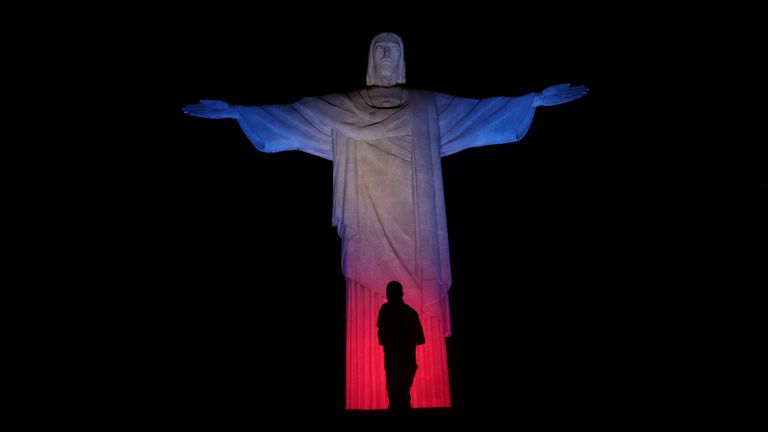 The Christ the Redeemer statue in Rio de Janeiro is illuminated with the Union Jack flag colors