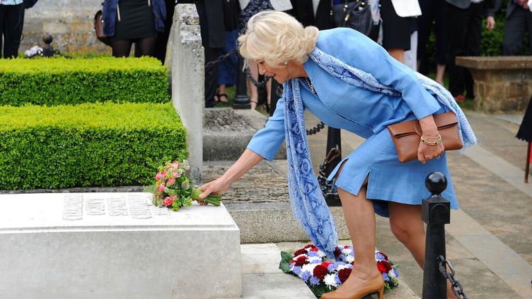 Queen Consort Camilla laying flowers on Sir Winston Churchill&#39;s grave at St Martin&#39;s Church in Bladon in 2015 Pic: AP