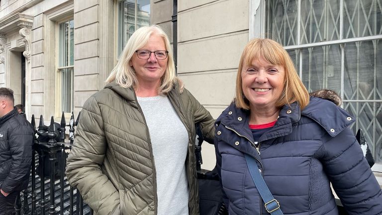 Sisters Carol Martin, 64, and Debbie Chitty, 62, listened to the service as it was played over loudspeakers on Parliament Street