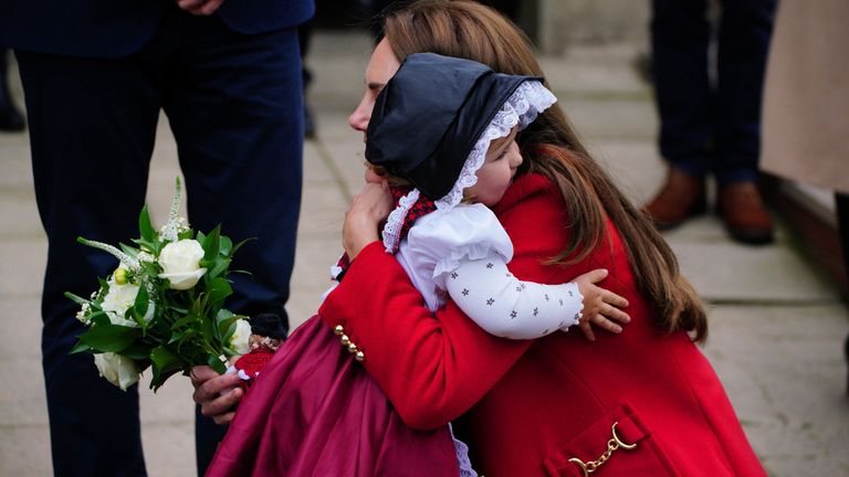 The Princess of Wales receives a posy of flowers and a hug from Charlotte Bunting, aged two, as she leaves after a visit to St Thomas Church, in Swansea, Wales. Picture date: Tuesday September 27, 2022.
