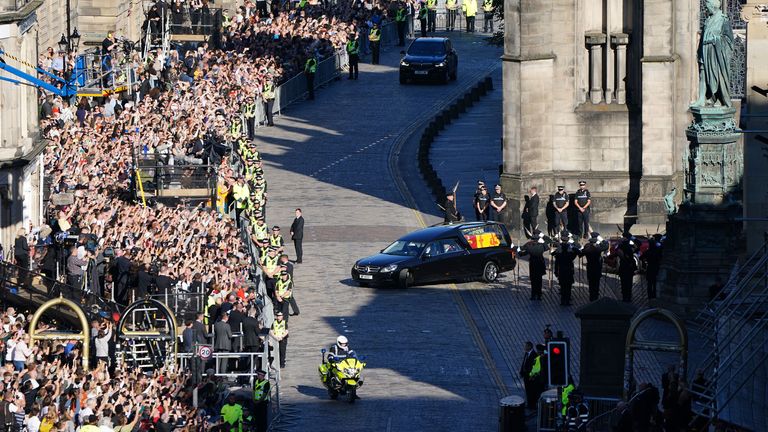 The hearse carrying the coffin of Queen Elizabeth II makes its way up the Royal Mile on the journey to Edinburgh Airport, where it will be flown by the Royal Air Force to RAF Northolt, then travel onward to Buckingham Palace, London, where it will lie at rest. Picture date: Tuesday September 13, 2022.