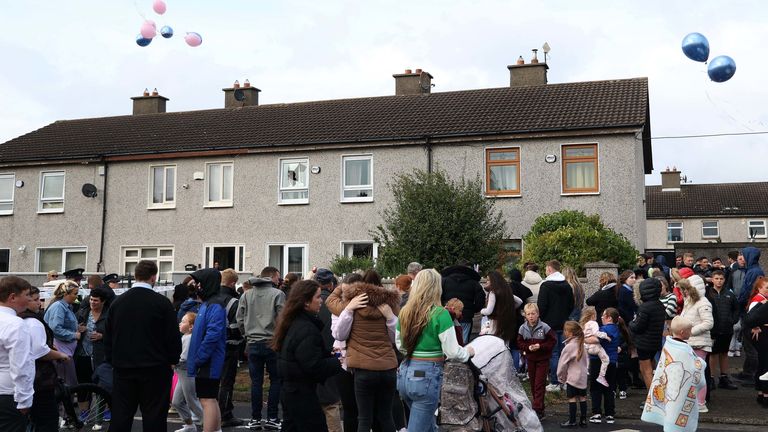 People attend a vigil following the deaths of three siblings in Tallaght