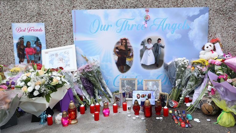 People attend a vigil following the deaths of three siblings in Tallaght