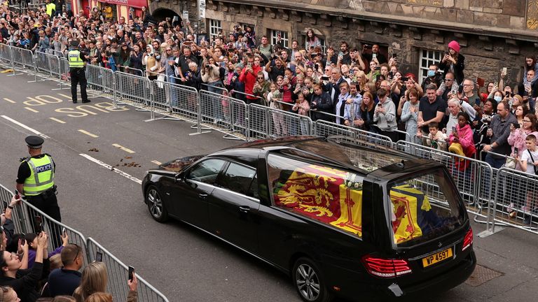 People watch the hearse carrying the coffin of Britain&#39;s Queen Elizabeth, at The Royal Mile in Edinburgh, Scotland, Britain, September 11, 2022. REUTERS/Lee Smith