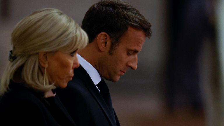 France's President Emmanuel Macron and first lady Brigitte Macron pay their respects to the coffin of Britain's Queen Elizabeth, following her death, during her lying-in-state at Westminster Hall, in London, Britain, September 18, 2022. REUTERS/John Sibley/Pool