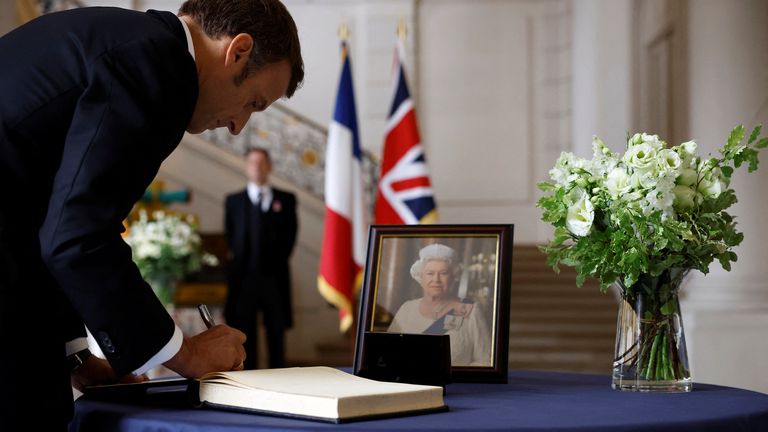 French President Emmanuel Macron signs a condolence book, following the passing of Britain&#39;s Queen Elizabeth, at the British Embassy in Paris, France, Friday, Sept. 9, 2022. Britain&#39;s longest-reigning monarch and a rock of stability across much of a turbulent century, died Thursday after 70 years on the throne. She was 96. (Christian Hartmann/Pool via AP)
