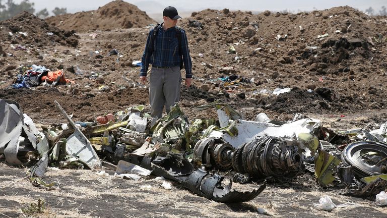 American civil aviation and Boeing investigators search through the debris at the scene of the Ethiopian Airlines Flight ET 302 plane crash, near the town of Bishoftu, southeast of Addis Ababa