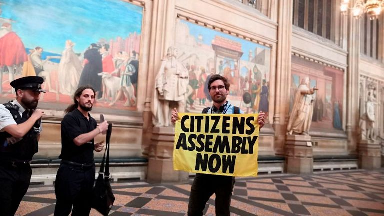 An Extinction Rebellion activist protests inside the parliament in London, Britain September 2, 2022 in this picture obtained from social media. Extinction Rebellion UK/via REUTERS THIS IMAGE HAS BEEN SUPPLIED BY A THIRD PARTY. MANDATORY CREDIT. NO RESALES. NO ARCHIVES.
