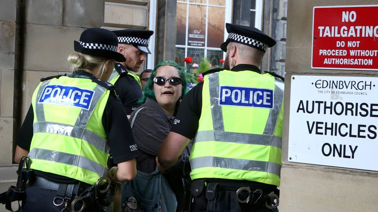 A Woman protester is taken away by Police at Meerkat Cross, Edinburgh ahead of the arrival of the coffin of HRH The Queen, which will be taken to Holyrood. 11/09/2022
PIC:SWNS