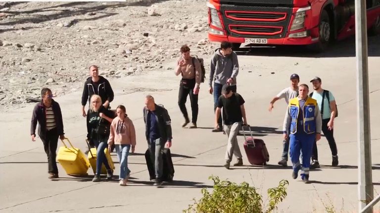 Russian men leaving the country through Georgia