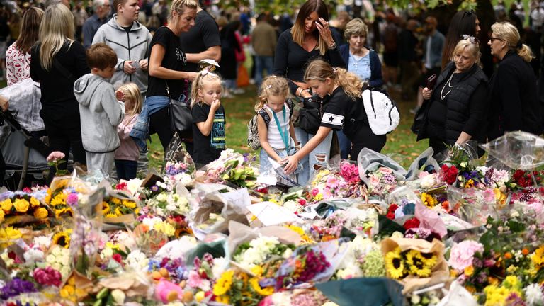People visit floral tributes placed in Green Park near Buckingham Palace, following the passing of Britain&#39;s Queen Elizabeth, in London, Britain, September 10, 2022. REUTERS/Henry Nicholls
