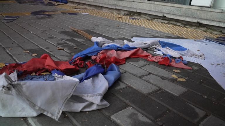 A torn Russian flag outside the central police station