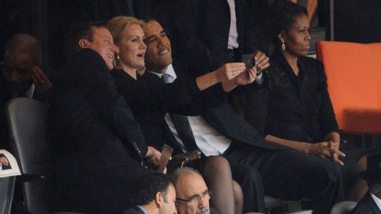 US President Barack Obama (R) and British Prime Minister David Cameron pose for a selfie picture with Denmark&#39;s Prime Minister Helle Thorning Schmidt (C) next to US First Lady Michelle Obama (R) during the memorial service of South African former president Nelson Mandela at the FNB Stadium (Soccer City) in Johannesburg on December 10, 2013. 
