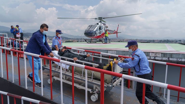 A Nepalese Sherpa guide who survived an avalanche at a low elevation on Mount Manaslu, the world's eighth highest mountain, was flown to a hospital in Kathmandu, Nepal, for treatment after being airlifted Tuesday, September 27, 2022. . An avalanche struck several climbers, killed a Nepalese guide and injured others. A search is under way the next day. (AP Photo/Niranjan Shrestha)