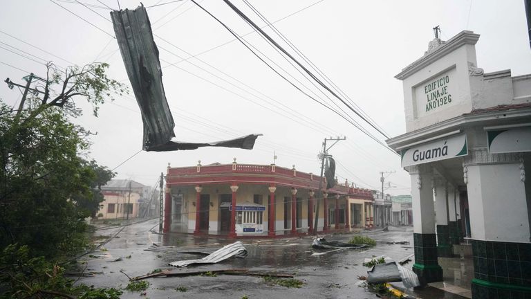 Debris hangs in the street as Hurricane Ian passes through Pinar del Rio, Cuba, September 27, 2022. REUTERS/Alexandre Meneghini