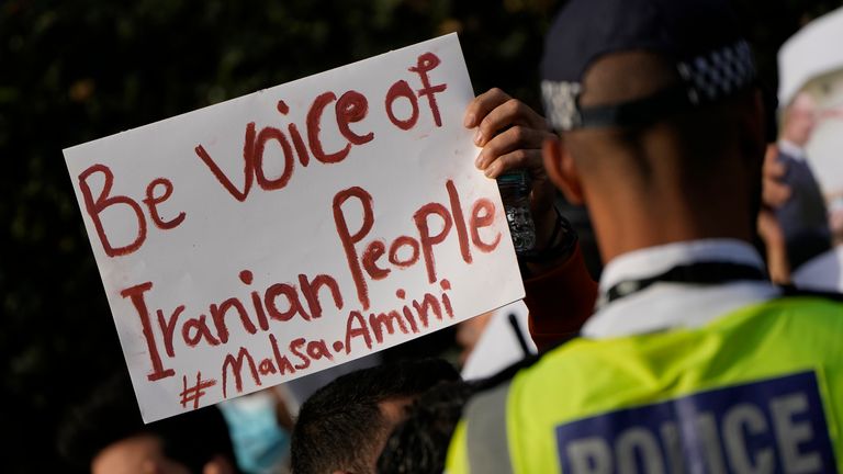 Demonstrators hold placards outside the Iranian Embassy in London, Sunday, Sept. 25, 2022. They were protesting against the death of Iranian Mahsa Amini, a 22-year-old woman who died in Iran while in police custody, who was arrested by Iran&#39;s morality police for allegedly violating its strictly-enforced dress code. (AP Photo/Alastair Grant)