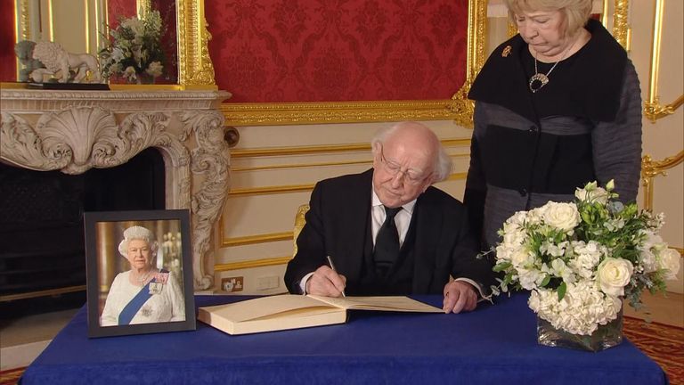The President of Ireland signs a book of condolences for the Queen