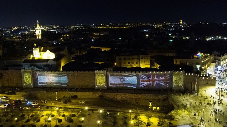 The Union Jack flag and Israel&#39;s national flag are projected on the walls of Jerusalem&#39;s Old City