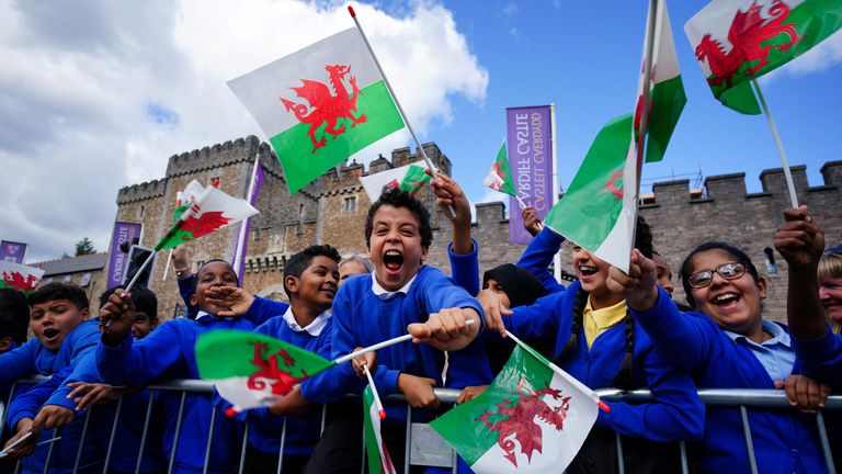 Schoolchildren wait for King Charles to arrive at Cardiff Castle