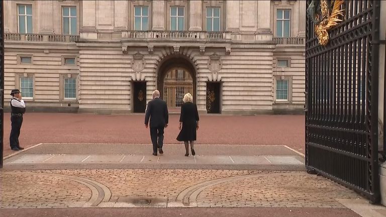 King Charles and Camilla walk into Buckingham Palace