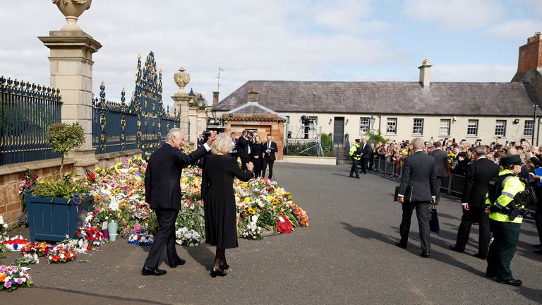 Britain&#39;s King Charles and Queen Camilla wave to people after viewing the  tributes at Hillsborough Castle, following the death of Queen Elizabeth, at Royal Hillsborough, Northern Ireland, September 13, 2022. REUTERS/Jason Cairnduff
