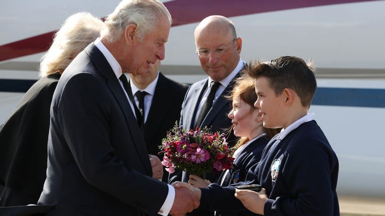 King Charles III is greeted by Ella Smith aged 10, and Lucas Watt aged 10 as he arrives at Belfast City Airport in Northern Ireland as the King continues his tour of the four home nations. Picture date: Tuesday September 13, 2022.
