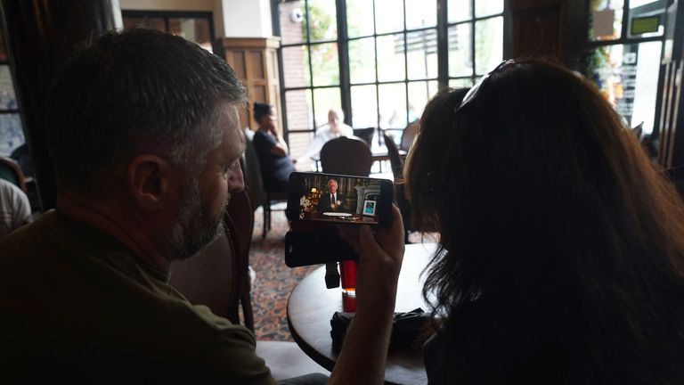 Members of the public at the King and Castle Pub in Windsor watching a broadcast of King Charles III first address to the nation as the new King following the death of Queen Elizabeth II on Thursday. Picture date: Friday September 9, 2022.