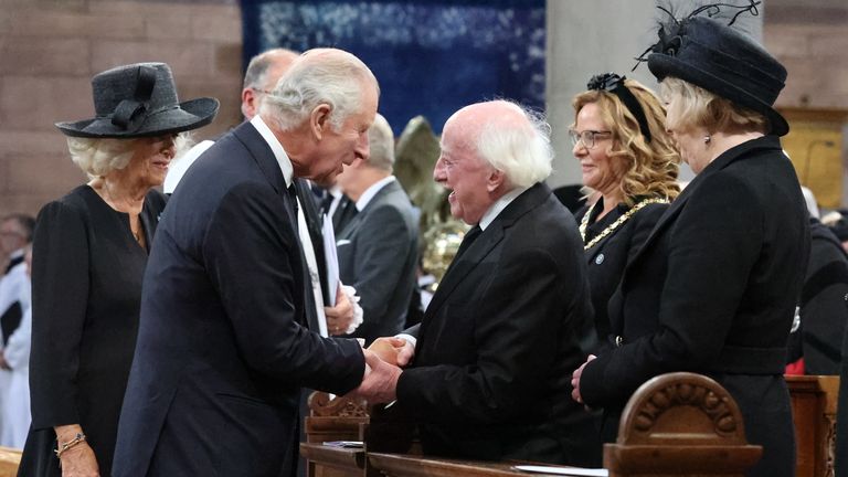 King Charles III and the Queen Consort greet President Michael D Higgins as they attend a Service of Reflection at St Anne's Cathedral in Belfast