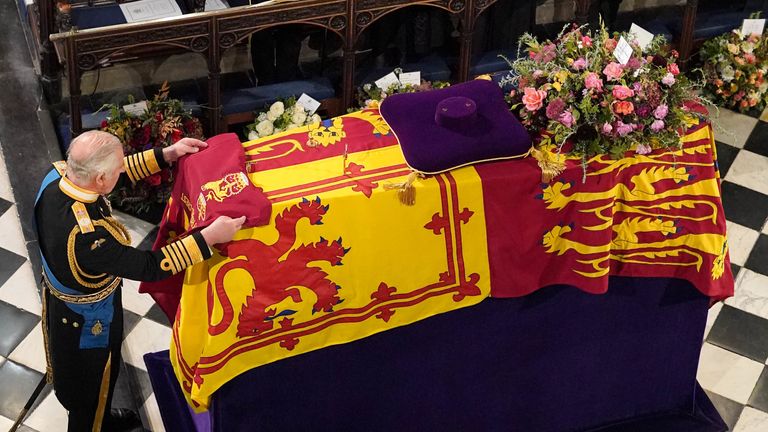 King Charles III places the the Queen&#39;s Company Camp Colour of the Grenadier Guards on the coffin