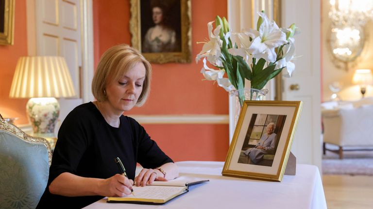 Prime Minister Liz Truss writes in a book of condolence at No10 Downing Street  