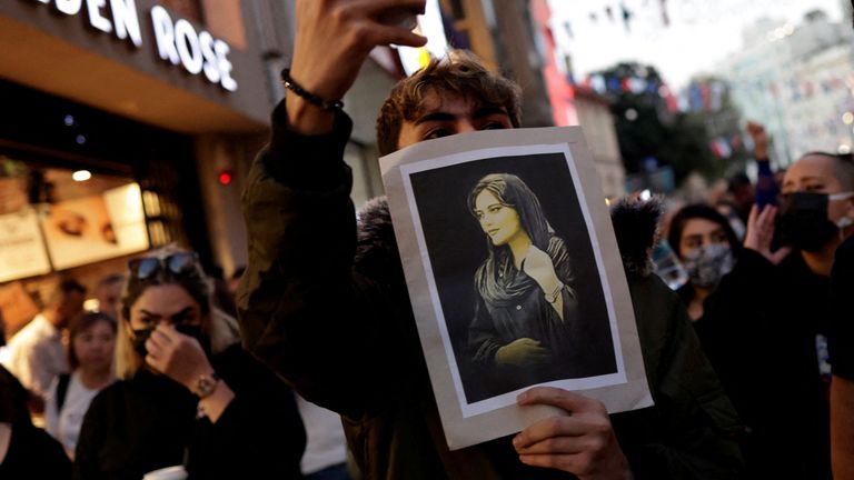 A demonstrator holds a picture of Mahsa Amini during a protest march in solidarity with women in Iran, following the death of the young Iranian woman, Mahsa Amini, in central Istanbul, Turkey September 20, 2022. REUTERS/Murad Sezer NO RESALES. NO ARCHIVES TPX IMAGES OF THE DAY