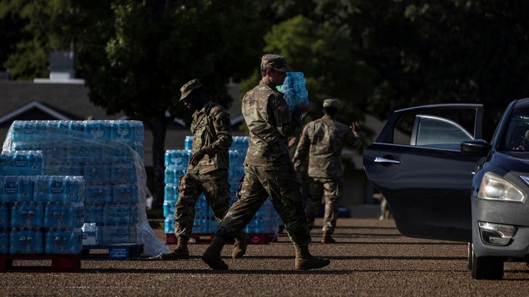 Members of the National Guard at a bottled water distribution site