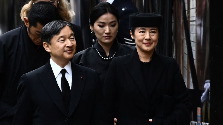 Japan&#39;s Emperor Naruhito and Japan&#39;s Empress Masako arrive to take their seats