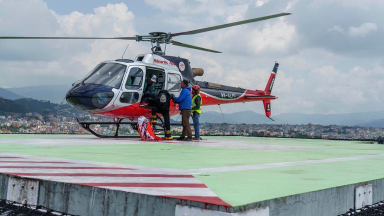 Two Nepali Sherpa guides, who survived a low-level avalanche on the world's eighth highest mountain, Mount Manaslu, are taken away for treatment after being airlifted to a hospital in Kathmandu, Nepal on Tuesday September 27, 2022. an avalanche swept away several climbers, killing a Nepalese guide and injuring other climbers.  Rescuers are also looking for Hilaree Nelson, a famous American ski mountaineer on Tuesday, a day after she fell from the mountain near the summit.  (AP Photo/Niranjan Shrestha)