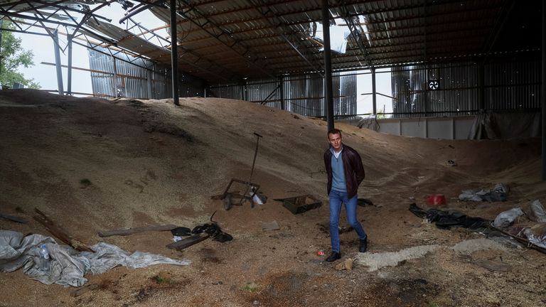 Vitali Orlov walks inside his destroyed grain silos, amid Russia&#39;s attack on Ukraine, in the village of Nova Husarivka, recently liberated by Ukrainian Armed Forces, in Kharkiv region, Ukraine September 15, 2022. REUTERS/Gleb Garanich
