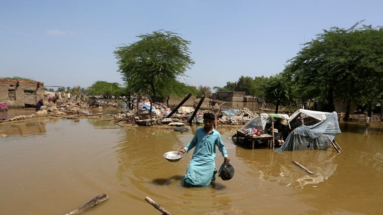 A man searches for salvageable belongings from his flooded house in the Shikarpur district of Sindh province, Pakistan, Thursday, September 1, 2022. Pakistani health officials on Thursday reported reported an outbreak of water-borne diseases in areas with recent record flooding, as authorities stepped up efforts to ensure clean water supplies for hundreds of thousands of people displaced by the disaster.  (AP Photo / Fareed Khan)
