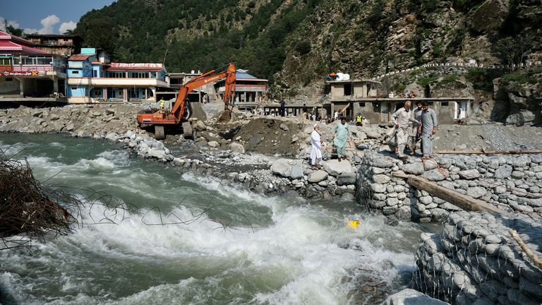 Diggers try to redirect river flow