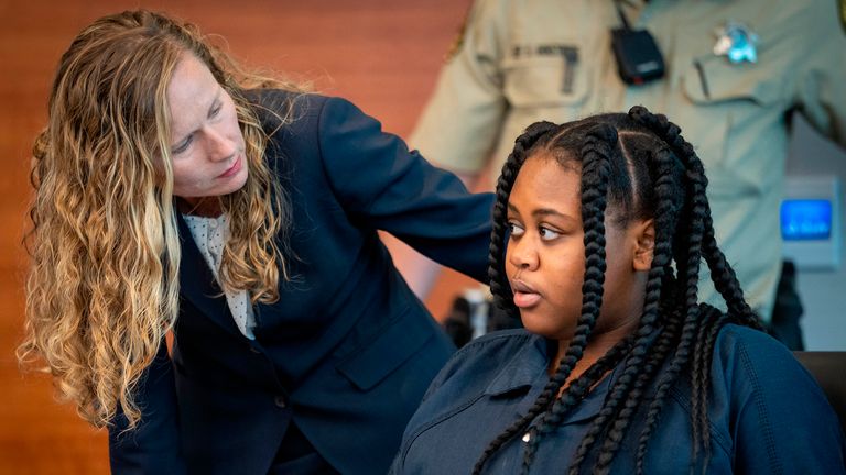 Pieper Lewis, right, speaks with attorney Magdalena Reese during a sentencing hearing Pic: AP