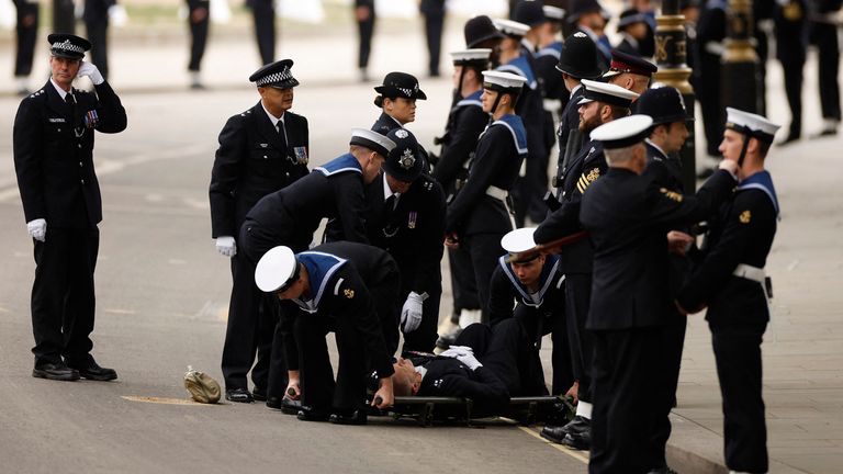A police officer is stretchered away after collapsing on the day of state funeral and burial of Britain&#39;s Queen Elizabeth, in London, Britain, September 19, 2022 REUTERS/John Sibley

