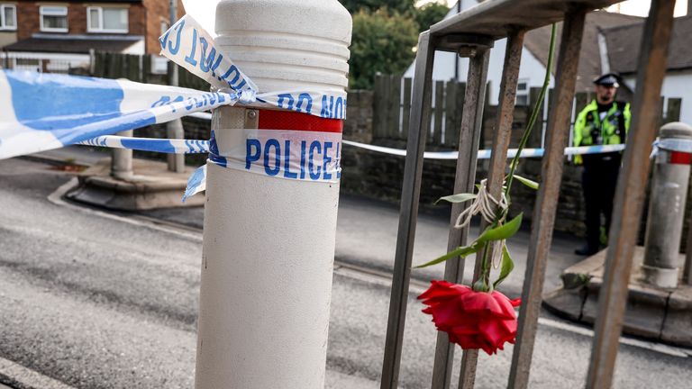 Police cordon and floral tributes near the scene in Woodhouse Hill, Huddersfield, where a 15-year-old boy was stabbed and later died in hospital on Wednesday. Picture date: Thursday September 22, 2022.
