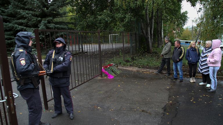 Policemen stand guard at the entrance of the school No. 88 after a shooting, in Izhevsk, Russia, Monday, Sept. 26, 2022. Authorities say a gunman has killed several people and wounded others in a school in central Russia. (AP Photo)