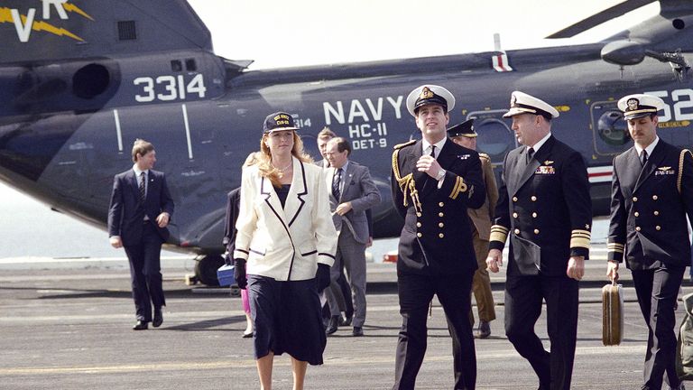 Prince Andrew and Sarah Ferguson and the Duke and Duchess of York are welcomed aboard the USS Nimitz on Thursday, March 3, 1988 by Vice Admiral John H. Fetterman Jr., commander U.S. Naval Air Forces Pacific, right. The Duke of York, a helicopter pilot in the Royal Navy, departed from the ship in an S-3A Viking anti-submarine warfare jet. (AP Photo/Nick Ut)
