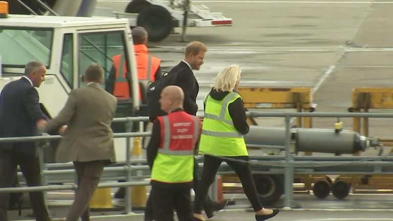 Prince Harry boards a plane in Aberdeen following the death of his grandmother, the Queen