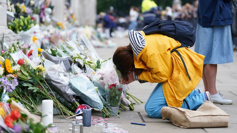 A woman mourns outside Buckingham Palace