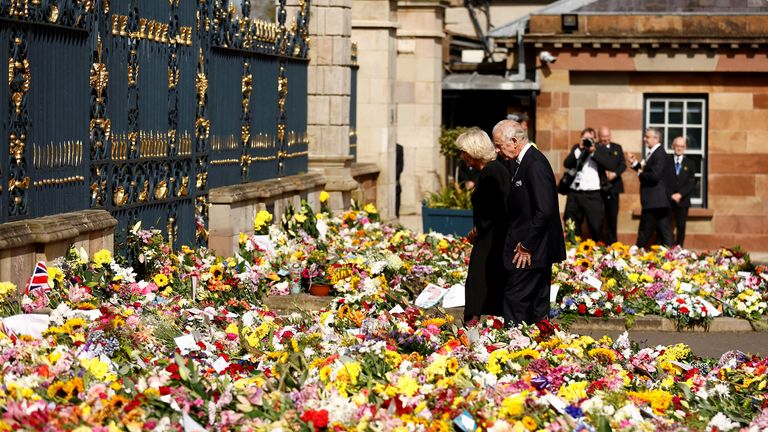 Britain&#39;s King Charles and Queen Camilla view the floral tributes at Hillsborough Castle, following the death of Queen Elizabeth, at Royal Hillsborough, Northern Ireland, September 13, 2022. REUTERS/Jason Cairnduff
