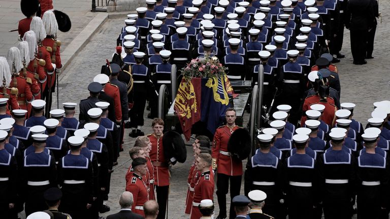 The coffin of Queen Elizabeth II is loaded on to a gun carriage pulled by Royal Navy soldiers to go from Westminster Hall for her funeral service in Westminster Abbey in central London, Monday Sept. 19, 2022. The Queen, who died aged 96 on Sept. 8, will be buried at Windsor alongside her late husband, Prince Philip, who died last year.     Nariman El-Mofty/Pool via REUTERS