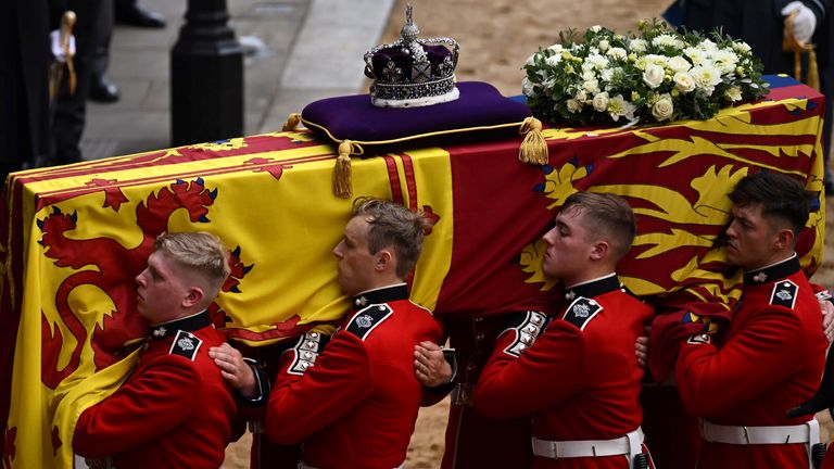 The Bearer Party from Queen&#39;s Company, 1st Battalion Grenadier Guards, carries the coffin of Queen Elizabeth II, draped in the Royal Standard with the Imperial State Crown placed on top, into Westminster Hall, London, where it will lie in state ahead of her funeral on Monday. Picture date: Wednesday September 14, 2022.